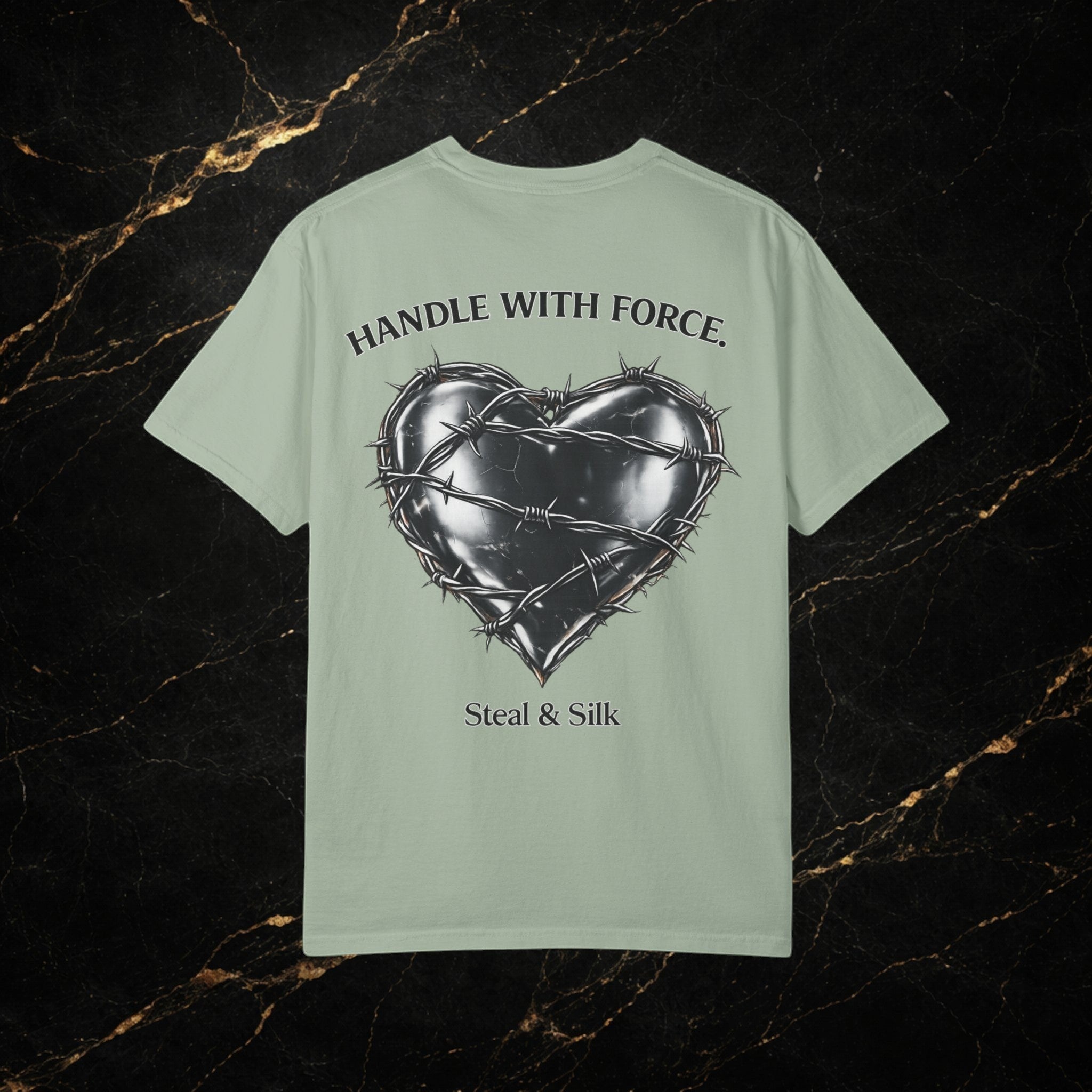 Steal & Silk light green cotton t-shirt with a black barbed wire heart graphic and "Handle With Force" text.