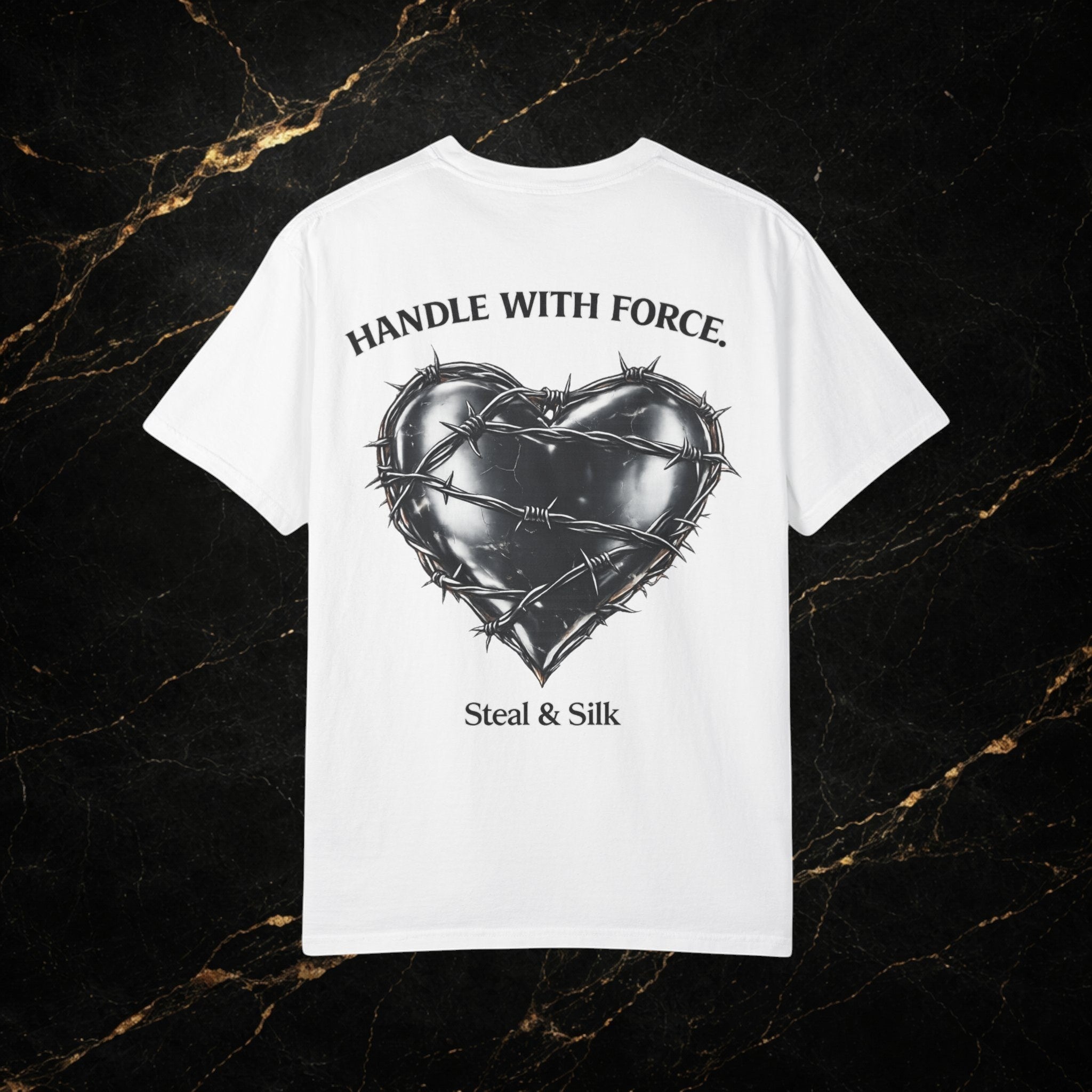 Steal & Silk white cotton t-shirt with a black barbed wire heart graphic and "Handle With Force" text.