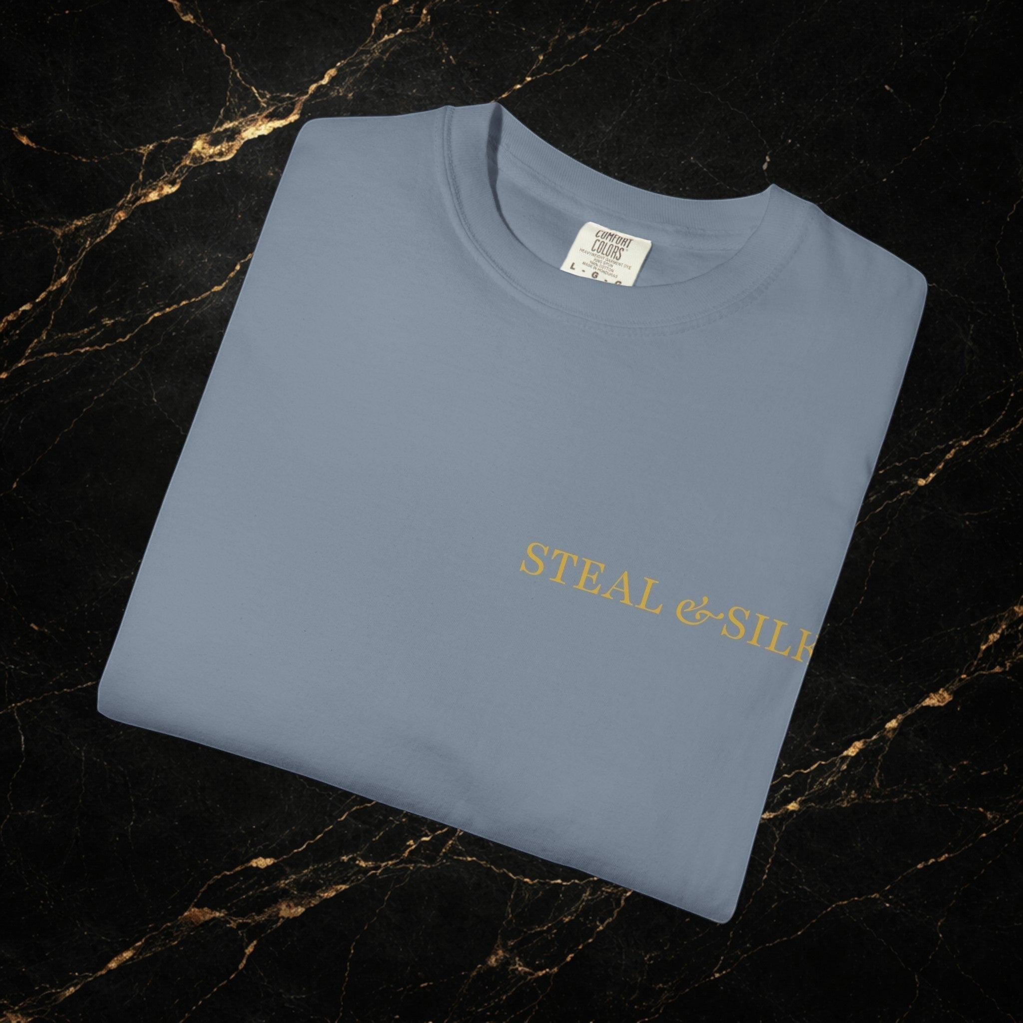 Steal & Silk light blue cotton t-shirt with gold "Handle With Force" heart graphic on front.
