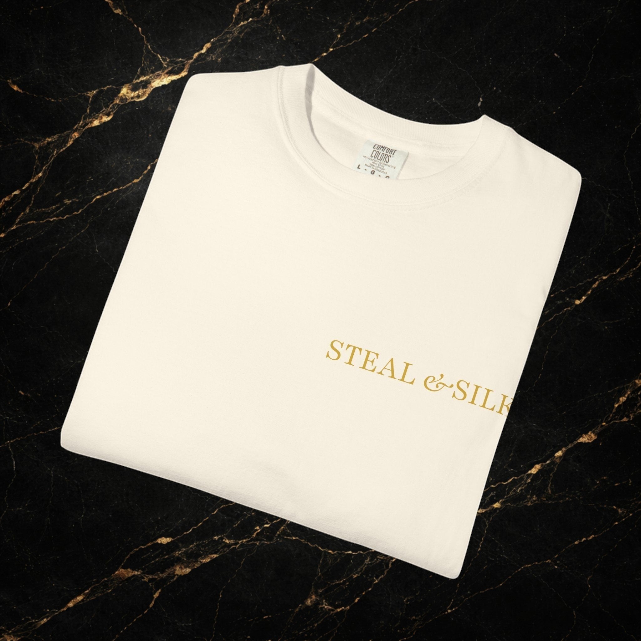 Steal & Silk cream cotton t-shirt with gold 'Handle With Force' heart graphic on the front.