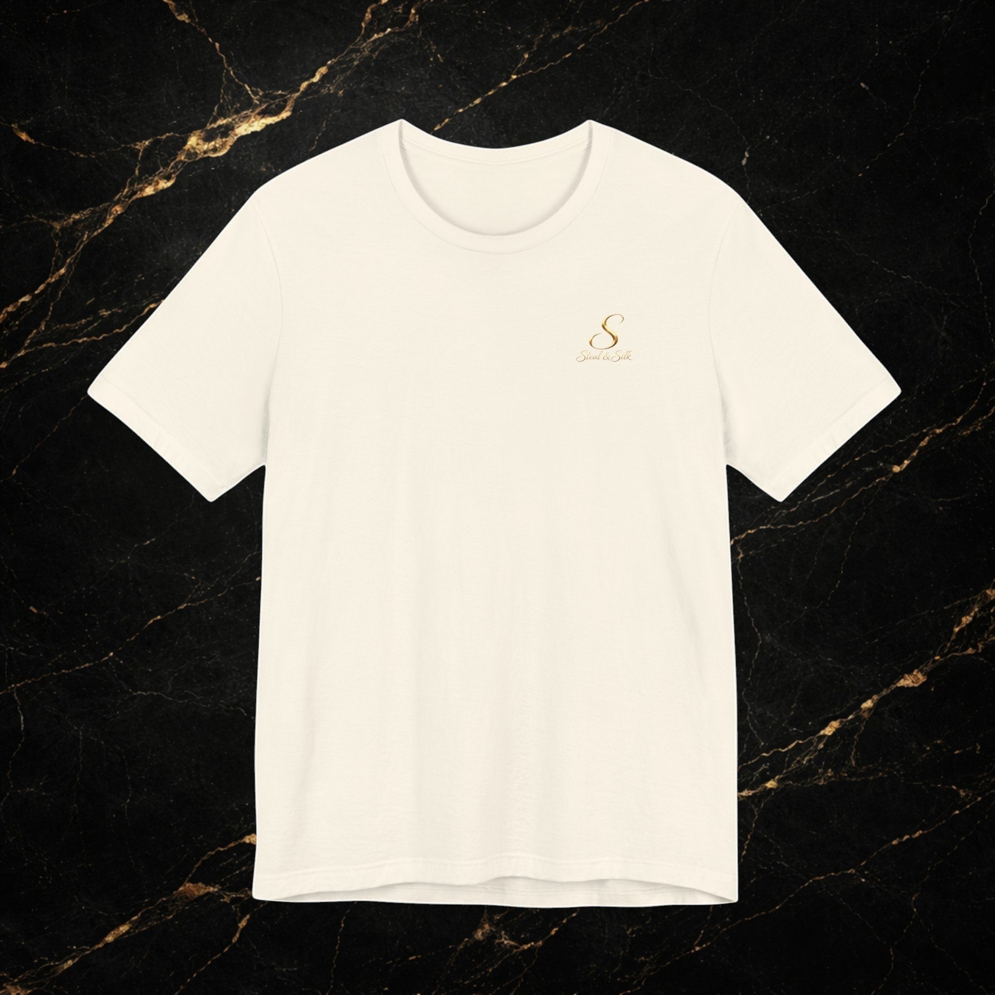 Steal & Silk cream cotton t-shirt with a small gold embroidered logo on the chest.