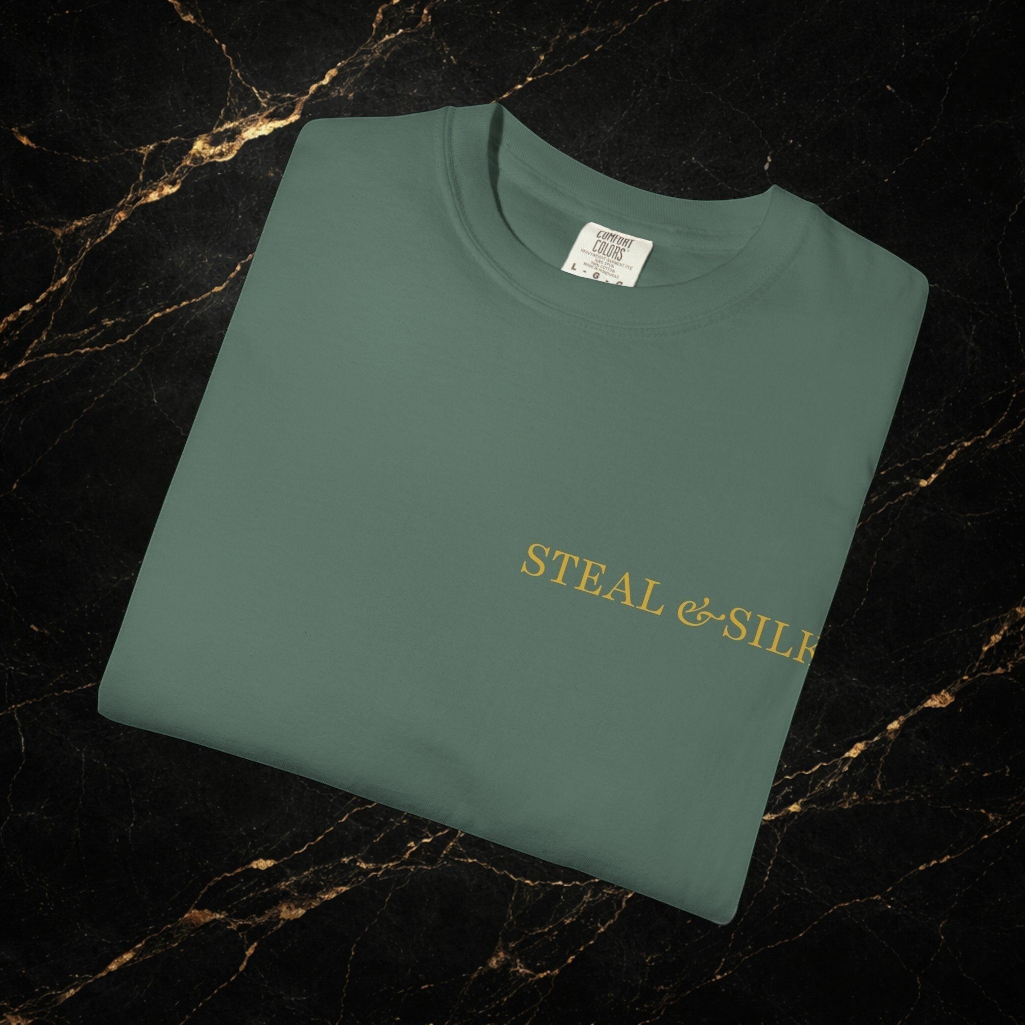 Steal & Silk green cotton t-shirt with gold "Handle With Force" heart graphic on the front.
