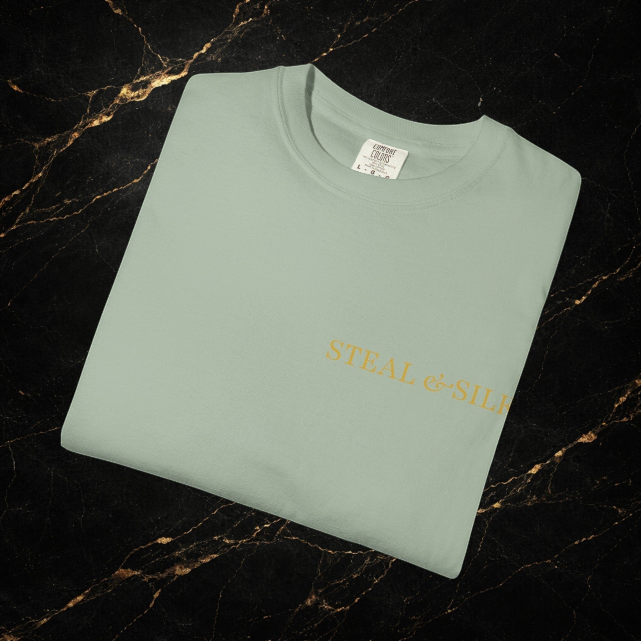 Steal & Silk pale green cotton t-shirt with "Handle With Force" heart graphic and brand logo.