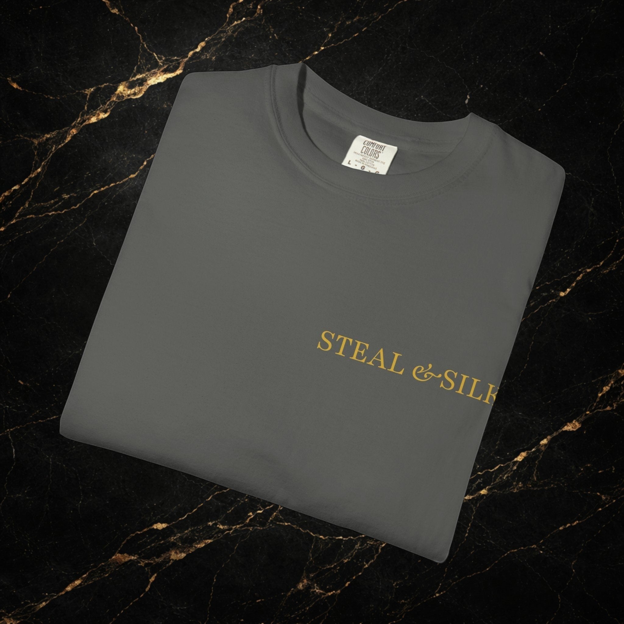 Steal & Silk charcoal grey cotton t-shirt with gold "Handle With Force" heart graphic on the chest.