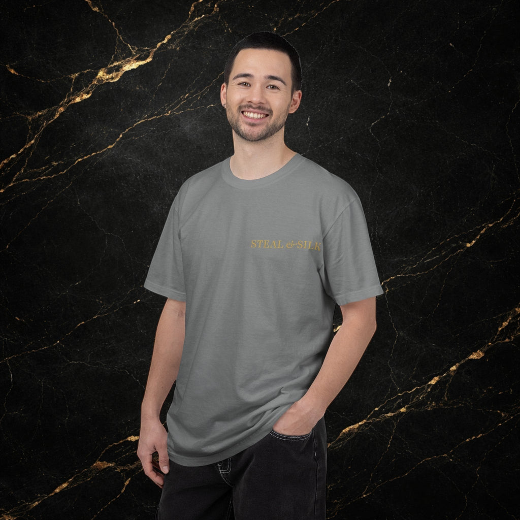 Steal & Silk grey cotton t-shirt with gold 'Handle With Force' heart graphic on chest. Model wearing dark jeans.
