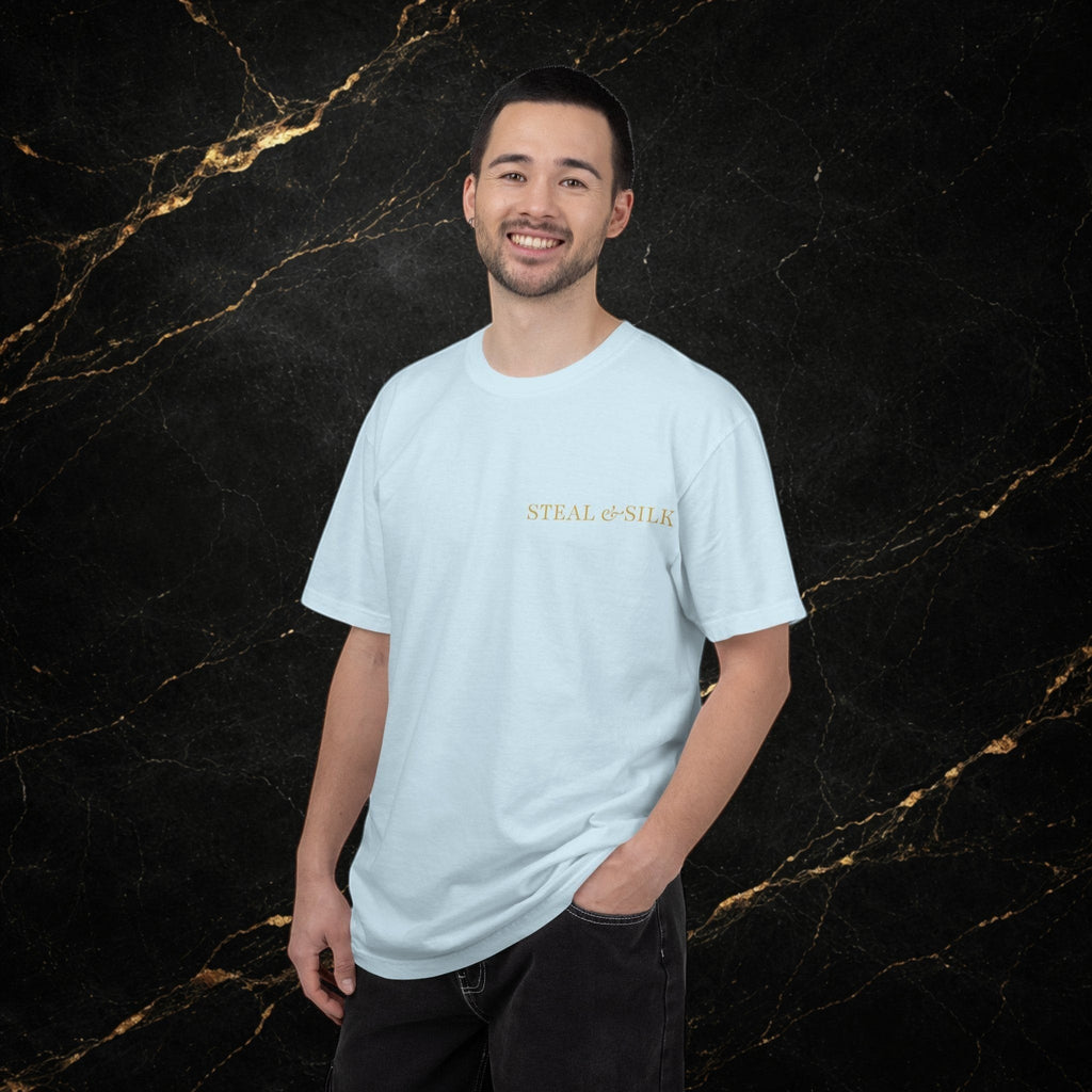 Steal & Silk light blue cotton t-shirt with gold "Handle With Force" heart graphic on chest. Model is wearing dark jeans.