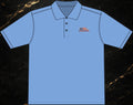 Steal & Silk light blue moisture-wicking work polo featuring an embroidered American flag logo on the chest.