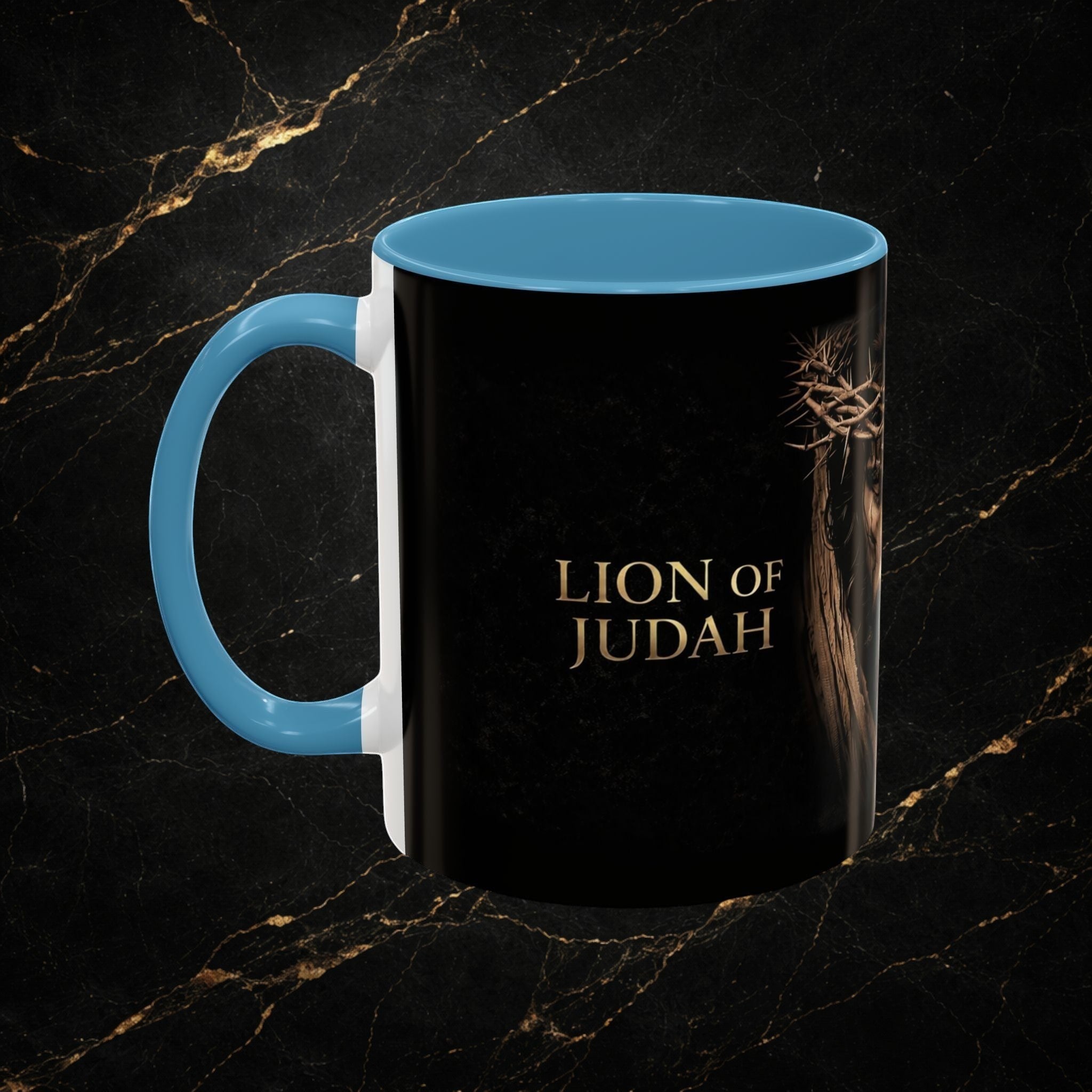 Steal & Silk black ceramic mug with blue handle and interior, featuring the "Lion of Judah" text and a crown of thorns graphic.