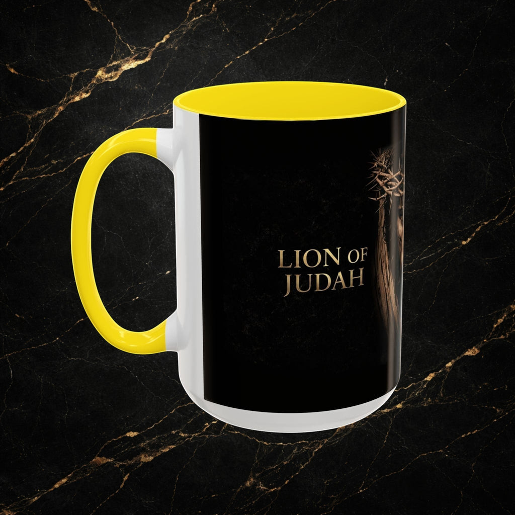 Steal & Silk white ceramic mug with yellow handle and interior, featuring a black exterior with "Lion of Judah" text and a depiction of Jesus' crown of thorns.