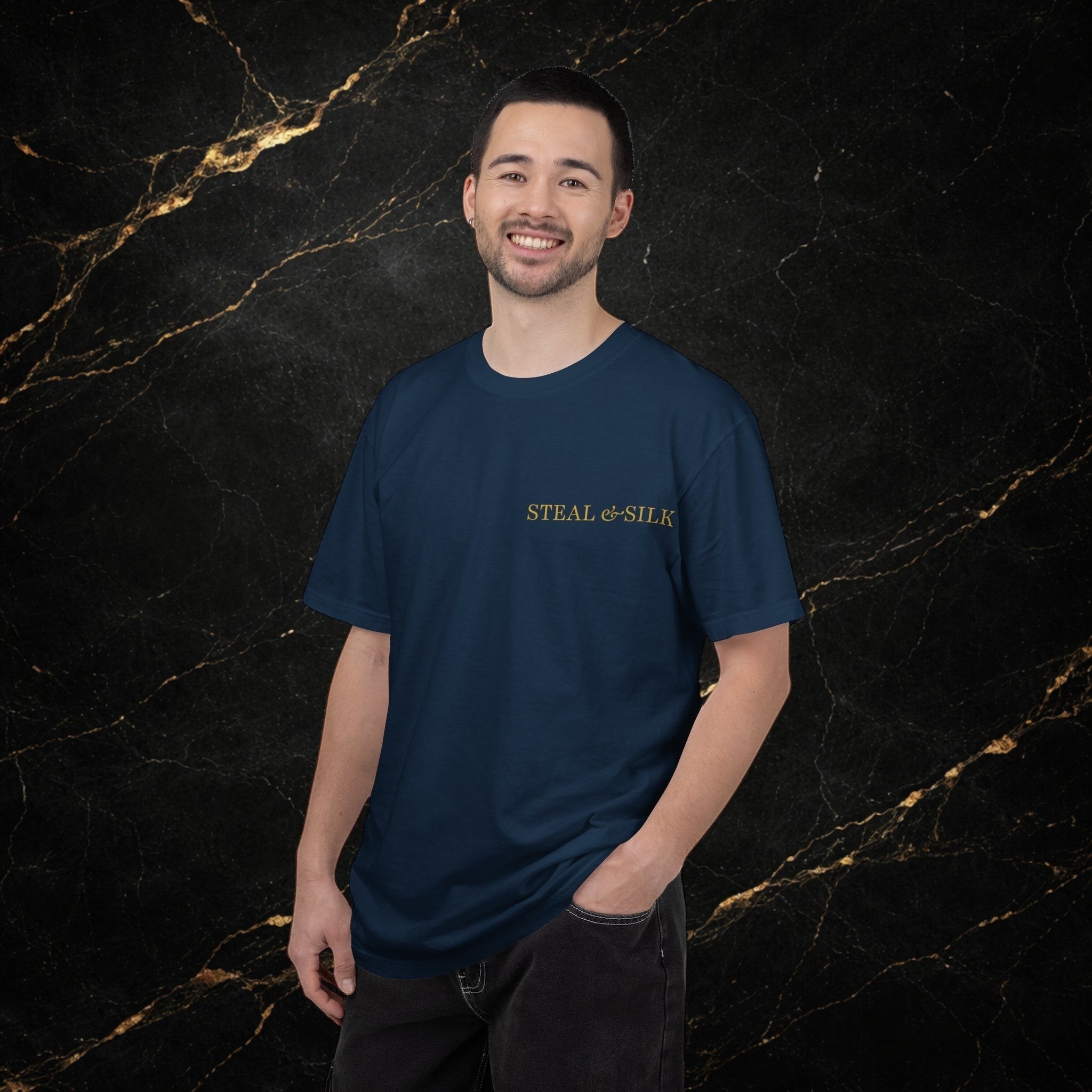 Steal & Silk navy blue cotton t-shirt with gold "Handle With Force" heart graphic on chest. Model wearing dark jeans.