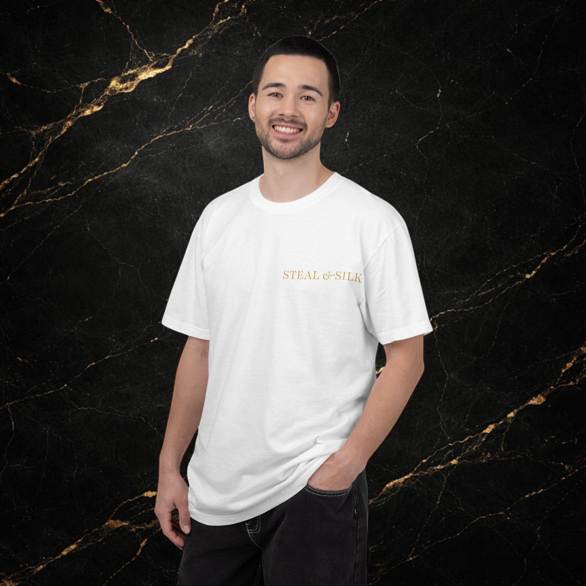 Steal & Silk white cotton t-shirt with gold "Handle With Force" heart graphic on chest. Model is wearing dark jeans.
