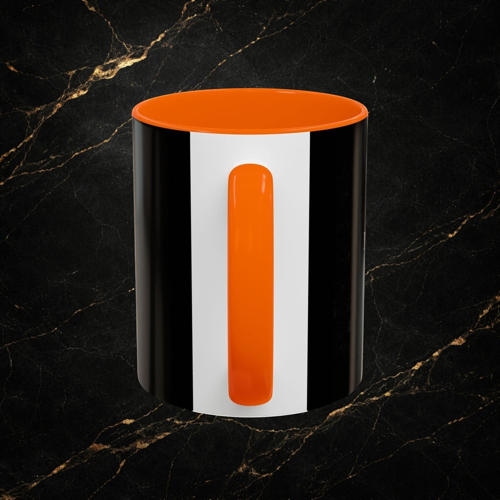 Steel & Silk black and white ceramic mug with orange handle and interior, featuring a bold stripe design.