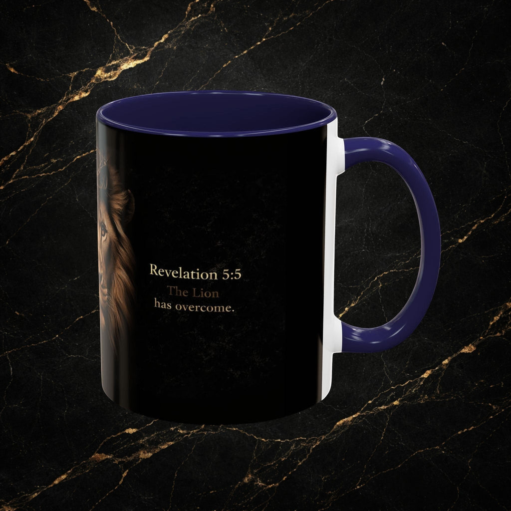 Steel & Silk ceramic mug featuring a Lion of Judah graphic and "Revelation 5:5 The Lion has overcome." text. Navy blue handle and interior.
