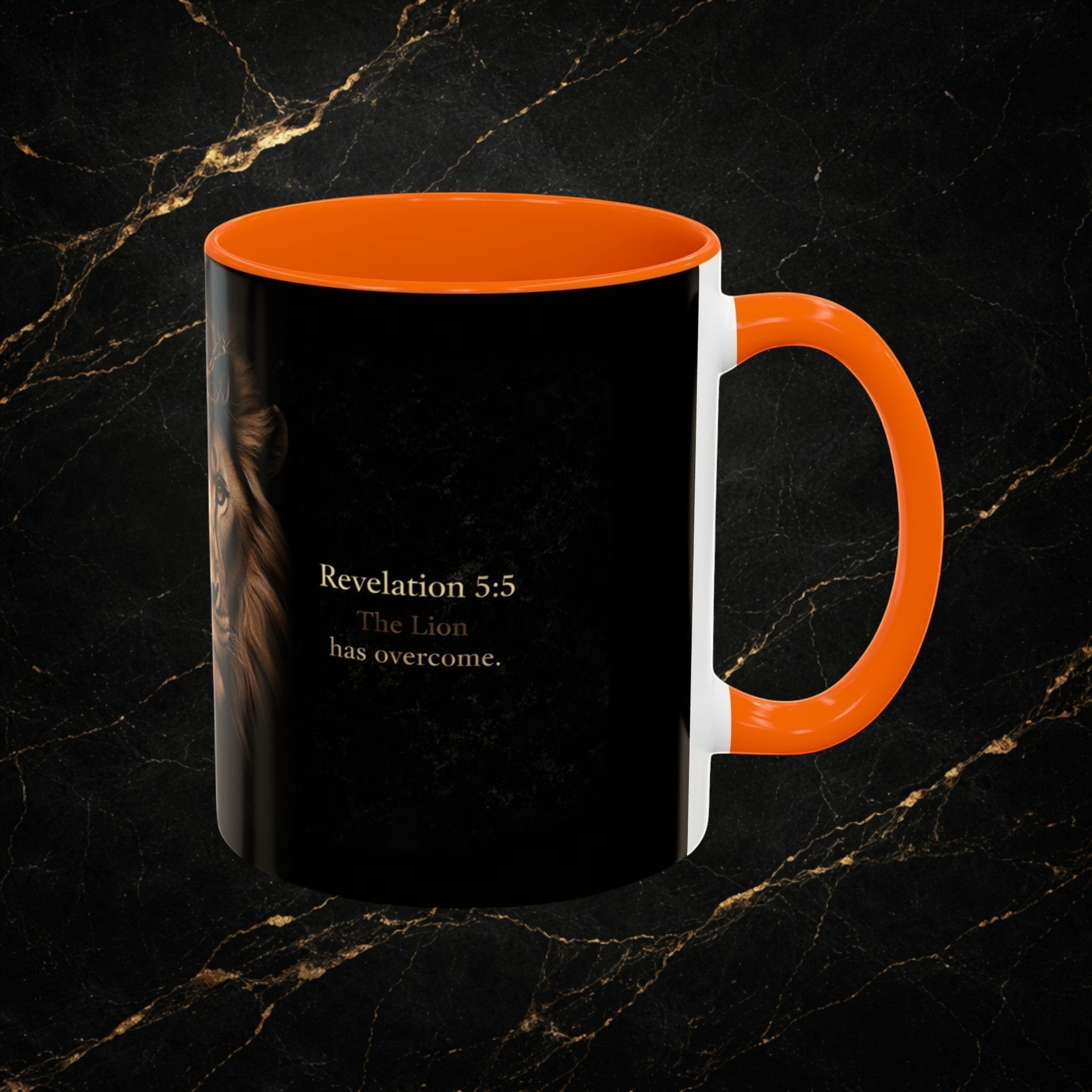 Steel & Silk black ceramic mug with orange handle featuring a lion's face and "Revelation 5:5 The Lion has overcome."